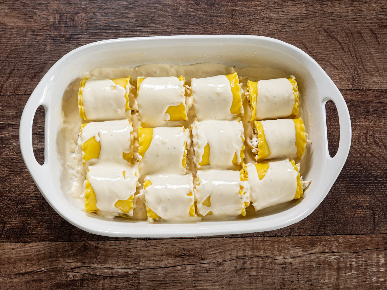 Place each lasagna roll up into the prepared casserole dish. Pour the remaining alfredo sauce over the lasagna roll-ups. Top with shredded mozzarella and parmesan cheese.